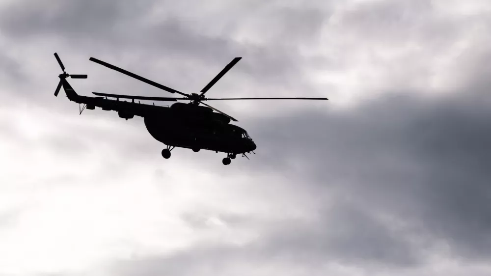 Silhouette of S Soviet helicopter Mi-8 common operational military aircraft aloft in the air cloudy sky