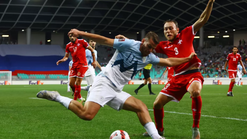 Soccer Football - World Cup - UEFA Qualifiers - Group H - Slovenia v Malta - Stozice Stadium, Ljubljana, Slovenia - September 4, 2021 Slovenia's Domen Crnigoj in action with Malta's Ryan Camenzuli REUTERS/Borut Zivulovic