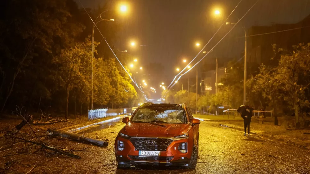 A resident walks near a destroyed car at the site of a Russian missile strike near a maternity hospital, amid Russia's attack on Ukraine in Kyiv, Ukraine September 24, 2026. REUTERS/Gleb Garanich