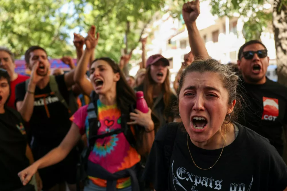 Housing activists react, after Maricarmen Abascal, 87, was taken away on a stretcher to an ambulance, after she was evicted from the Madrid home where she had lived for more than seven decades after the apartment was acquired by an investment fund that sought a steep increase in her rent, despite efforts by housing activists to broker an alternative arrangement in Madrid, Spain, September 23, 2026. REUTERS/Susana Vera