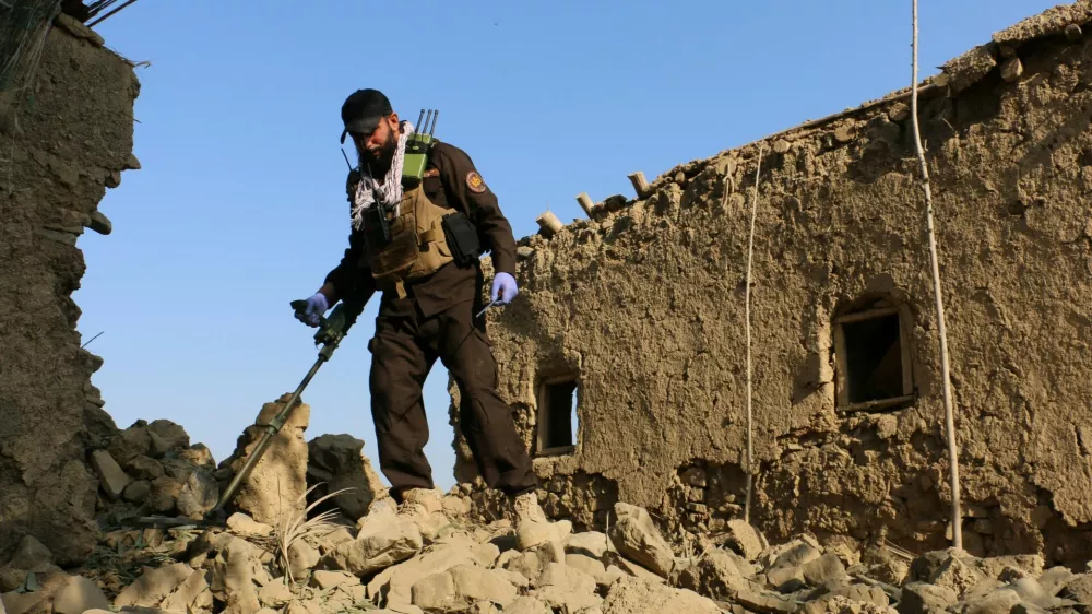 A member of Taliban security forces uses a metal detector amid the rubble of a house that was damaged in what the Taliban said was a Pakistani airstrike in Gurbuz district of Khost province, Afghanistan, September 24, 2026. REUTERS/Stringer