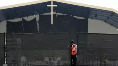 A member of security personnel stands near fences as workers set up infrastructure for an open-air Mass to be celebrated by Pope Leo at the Place de la Concorde in Paris on the eve of his four-day apostolic journey to France, September 24, 2026. REUTERS/Benoit Tessier