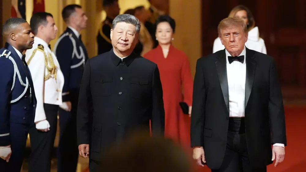 President Donald Trump arrives with China's President Xi Jinping and first lady Melania Trump and Peng Liyuan during a State Dinner for China's President Xi Jinping in the East Room of the White House, Thursday, Sept. 24, 2026, in Washington. (AP Photo/Alex Brandon)