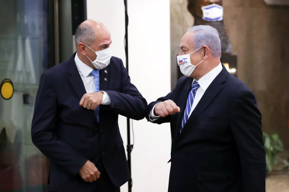 Slovenian Prime Minister Janez Jansa and Israeli Prime minister Benjamin Netanyahu wear protective masks as they meet in Jerusalem December 8, 2020. Ohad Zwigenberg/Pool via REUTERS