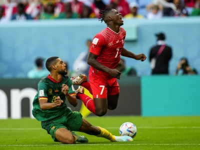 Cameroon's Jean-Charles Castelletto, left, vies for the ball with Switzerland's Breel Embolo during the World Cup group G soccer match between Switzerland and Cameroon, at the Al Janoub Stadium in Al Wakrah, Qatar, Thursday, Nov. 24, 2022. (AP Photo/Petr Josek)