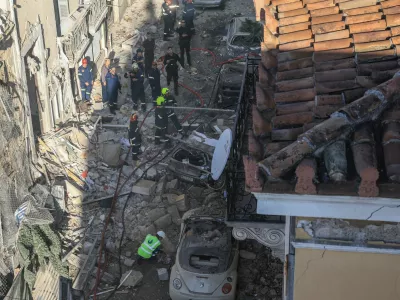 Emergency personnel work at the site where an old building partially collapsed following an explosion, at the touristy Plaka area in central Athens, Greece, September 25, 2026. REUTERS/Louisa Gouliamaki