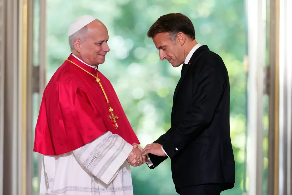Pope Leo XIV, left, and French President Emmanuel Macron shake hands after a joint statement at the Elysee Palace, Friday, Sept. 25, 2026. (AP Photo/Teresa Suarez, Pool)