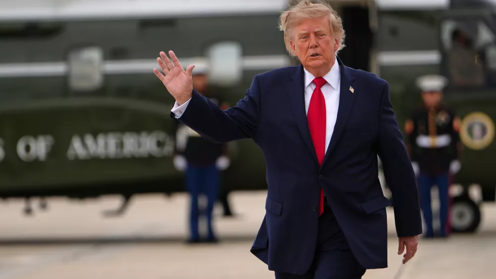 President Donald Trump waves as he walks from Marine One to board Air Force One, Saturday, Sept. 26, 2026, at Joint Base Andrews, Md. (AP Photo/Julia Demaree Nikhinson)