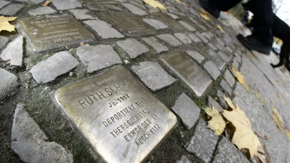 Pedestrians walk past so-called 'Stolpersteine' (stumbling blocks), memorial pavement plaques commemorating German Jews who died in the concentration camps of Auschwitz and Theresienstadt, in Berlin's Wilmersdorf district November 7, 2008. German artist Gunter Demnig has embedded into pavements across Germany, Austria, Hungary and the Netherlands where Jews were living during the Nazi era.    REUTERS/Fabrizio Bensch (GERMANY) - BM2E4B715CC01