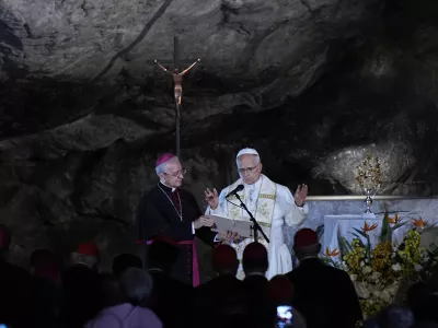 Pope Leo XIV prays at the Grotto of the Apparitions of Massabielle, in Lourdes, France, Saturday, Sept. 26, 2026. (AP Photo/Laurent Cipriani)