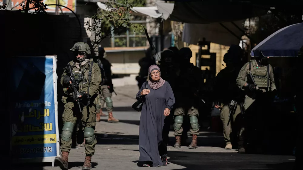 Israeli soldiers take positions during a military operation at a market in Nablus, West Bank, Sunday, Sept. 27, 2026. (AP Photo/Majdi Muhammad)