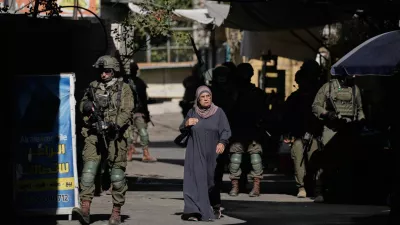 Israeli soldiers take positions during a military operation at a market in Nablus, West Bank, Sunday, Sept. 27, 2026. (AP Photo/Majdi Muhammad)