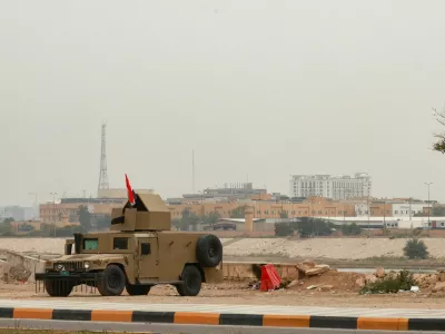 An Iraqi army Humvee stands guard near the U.S. Embassy, after Iraqi security sources said the embassy was hit in a missile attack, in Baghdad, Iraq, March 14, 2026. REUTERS/Ahmed Saad