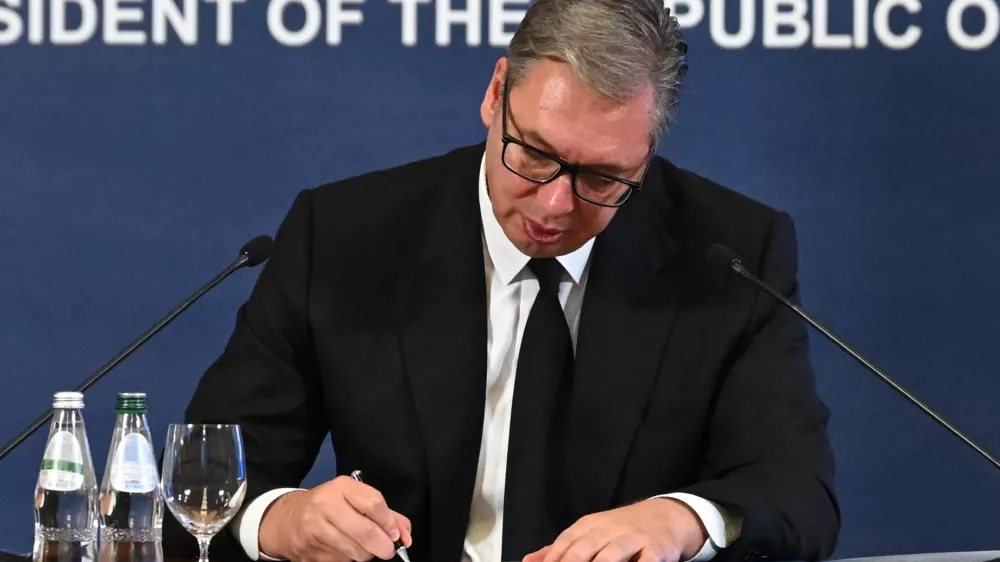 This photo released by Serbia's presidential press office shows Serbian President Aleksandar Vucic signing his resignation as President of the Republic, in order to run for prime minister, in Belgrade, Serbia, Sunday, Sept. 27, 2026. (Serbian presidential press office via AP)