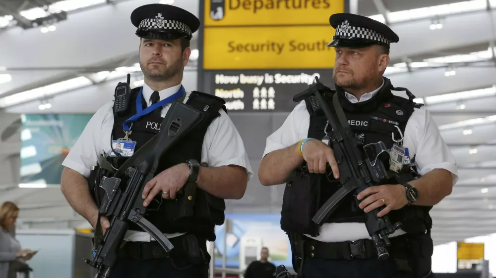 Armed police patrol at Terminal 5, Heathrow Airport in London, Britain, in this file photograph dated March 22, 2016. Facial recognition software, scanners that detect weapons and cameras that spot nervous people are some of the technologies that could be used more widely to secure public places, but some would require greater acceptance of surveillance in Europe. REUTERS/Luke MacGregor/Files