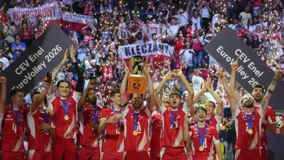 Poland's Aleksander Sliwka, center, holds the trophy as he celebrates with teammates on the podium after winning the men's European volleyball championship final match against France in Milan, Saturday, Sept. 26, 2026. (AP Photo/Antonio Calanni)