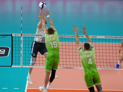 Finland's Joonas Jokela, left, spikes the ball as Slovenia's Rok Mozic and Jan Kozamernik try to block during the men's European volleyball championship third-place final match between Finland and Slovenia in Milan, Italy, Saturday, Sept. 26, 2026. (AP Photo/Antonio Calanni)