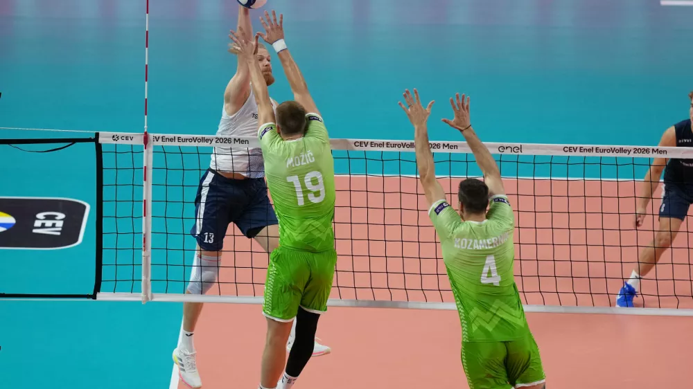 Finland's Joonas Jokela, left, spikes the ball as Slovenia's Rok Mozic and Jan Kozamernik try to block during the men's European volleyball championship third-place final match between Finland and Slovenia in Milan, Italy, Saturday, Sept. 26, 2026. (AP Photo/Antonio Calanni)