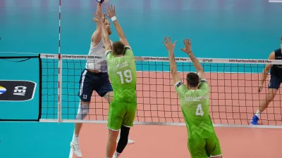 Finland's Joonas Jokela, left, spikes the ball as Slovenia's Rok Mozic and Jan Kozamernik try to block during the men's European volleyball championship third-place final match between Finland and Slovenia in Milan, Italy, Saturday, Sept. 26, 2026. (AP Photo/Antonio Calanni)