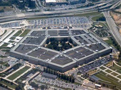 Aerial view of the Pentagon complex with surrounding roads, parking and greenery. g.