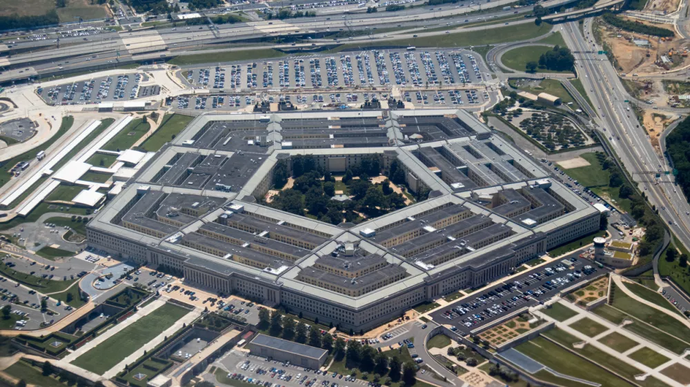 Aerial view of the Pentagon complex with surrounding roads, parking and greenery. g.