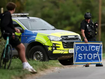 Armed police officer works on a road outside the perimeter of the RAF Fairford airbase, after police declared a major incident at the base after several men were arrested on suspicion of offences under the Explosives Act, in Fairford, Gloucestershire, Britain, September 28, 2026. REUTERS/Toby Shepheard   TPX IMAGES OF THE DAY