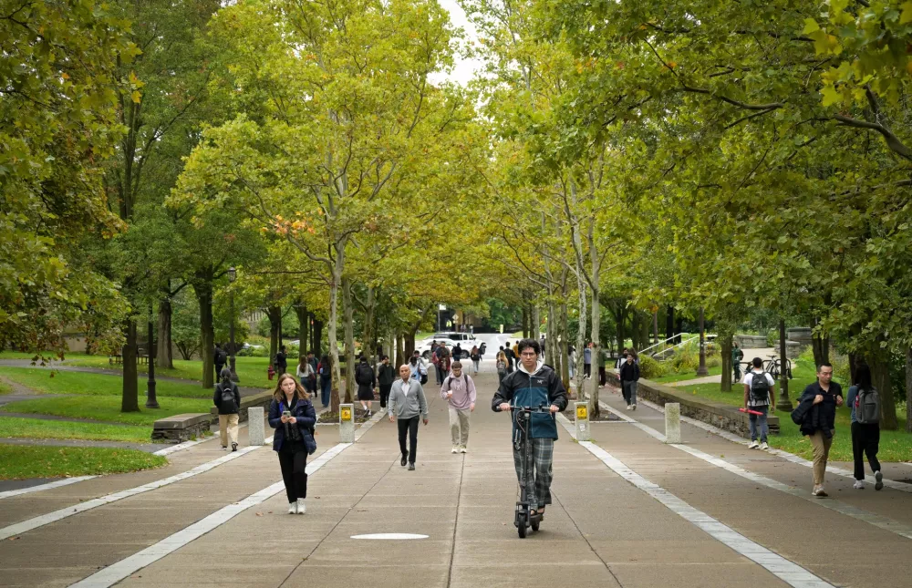 People walk in Ho Plaza at Cornell University in Ithaca, N.Y., Monday, Sept. 28, 2026. (AP Photo/Heather Ainsworth)