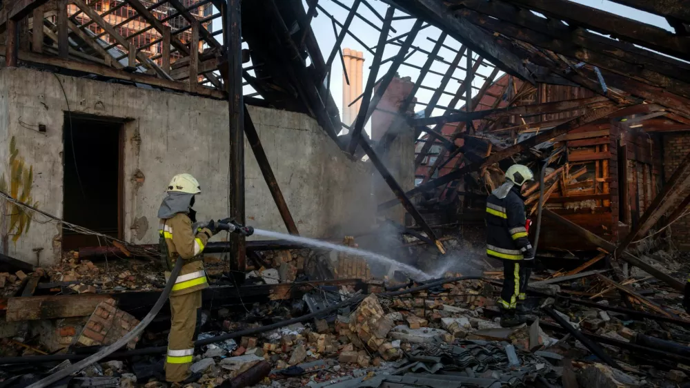 Firefighters work in the attic of a residential building that caught fire after it was struck by a Russian jet-powered drone, amid Russia's attack on Ukraine, in Kyiv, Ukraine, September 29, 2026. REUTERS/Thomas Peter