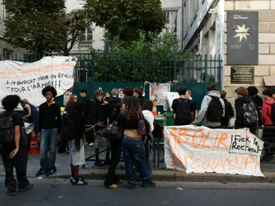 French high school students block access of the Lycee Simone Veil high school in Paris as part of a day of strikes and protests by public sector workers, including firefighters, in France, September 29, 2026. The slogans on the banners read "Make love, not war. More funding for schools and less for the army" and "Abolish Parcoursup!". REUTERS/Tom Nicholson