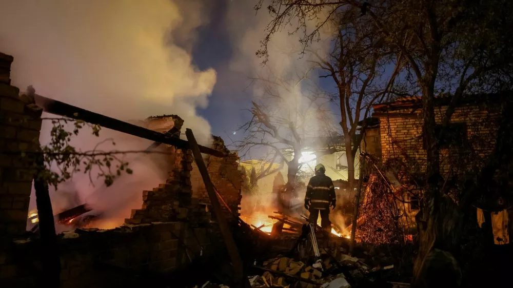 A firefighter works at the site of a private house hit by a Russian drone strike, amid Russia's attack on Ukraine, in Kyiv, Ukraine September 30, 2026. REUTERS/Gleb Garanich