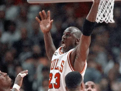 FILE - In this June 10, 1998, file photo, Cicago Bulls' Michael Jordan reaches high above teammates Dennis Rodman, left, Scottie Pippen, and Scott Burrell (24) for a rebound against the Utah Jazz in the second half of Game 4 in the NBA Finals in Chicago. Jordan described his final NBA championship season with the Chicago Bulls as a &acirc;&euro;śtrying year.&acirc;&euro;ť &acirc;&euro;śWe were all trying to enjoy that year knowing it was coming to an end,&acirc;&euro;ť Jordan told Good Morning America on Thursday, April 16, 2020. (AP Photo/Michael S. Green, File)