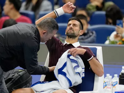 Novak Djokovic of Serbia receives a medical timeout during the first round of the men's singles match against Nuno Borges of Portugal in the China Open tennis tournament in Beijing, Wednesday, Sept. 30, 2026. (AP Photo/Andy Wong)