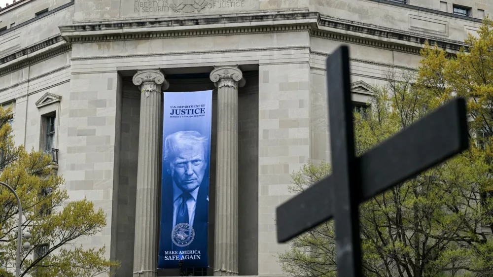 A cross carried as part of a Way of the Cross procession to mark Good Friday passes the U.S. Department of Justice building as it takes place in Washington, D.C., U.S., April 3, 2026. REUTERS/Annabelle Gordon