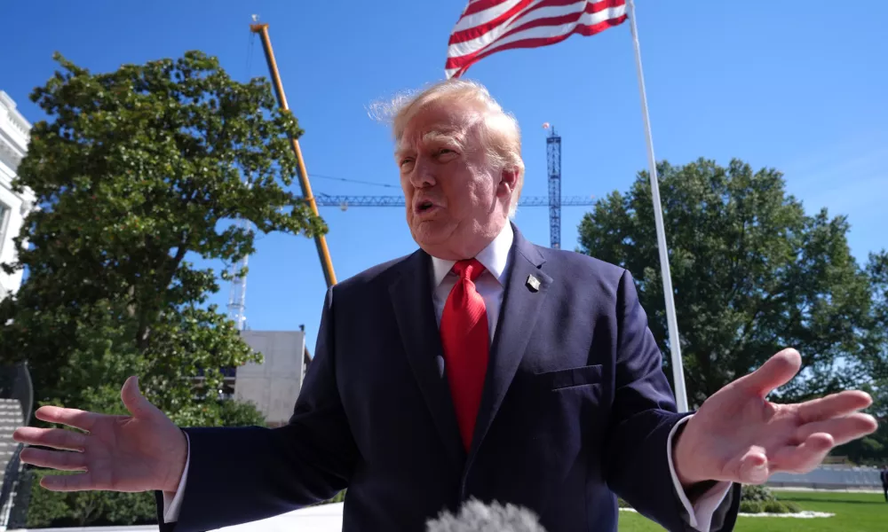 President Donald Trump speaks with reporters before boarding Marine One on the South Lawn of the White House, Thursday Oct. 1, 2026, in Washington. (AP Photo/Jacquelyn Martin)