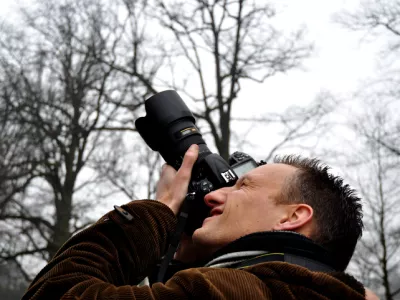 Professional photographer focusing digital camera