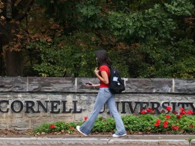 A student walks by a sign at the entrance of Cornell University in Ithaca, New York, US, October 1, 2026. REUTERS/Lauren Petracca