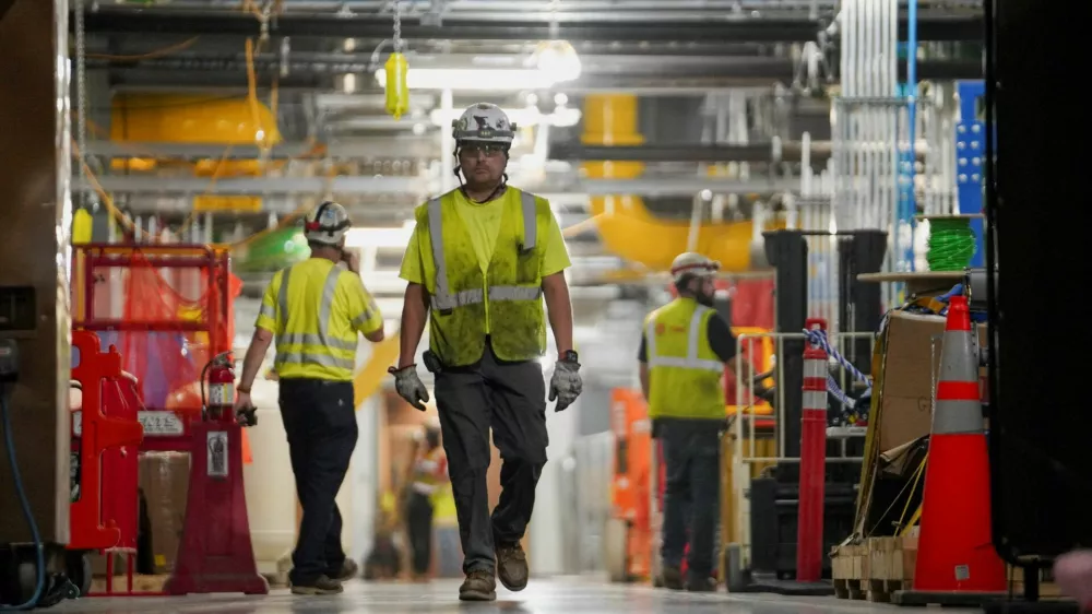 FILE PHOTO: People work inside the Microsoft data center campus' Graphical Processing Unit, currently under construction, after Microsoft's Vice Chair and President Brad Smith announced a plan to spend $4 billion on an additional artificial intelligence data center, in Mount Pleasant, Wisconsin, U.S., September 18, 2025. REUTERS/Audrey Richardson/File Photo/File Photo