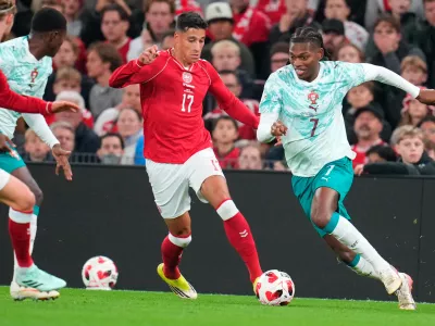Denmark's Adam Daghim and Portugal's Rafael Leao, right, in action during the Nations League soccer match between Denmark and Portugal, in Copenhagen, Thursday, Oct. 1, 2026. (Liselotte Sabroe/Ritzau Scanpix via AP)