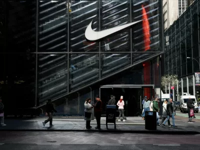 FILE PHOTO: People walk past a Nike store in New York City, U.S., April 2, 2025. REUTERS/Kylie Cooper/File Photo