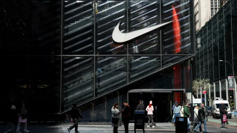 FILE PHOTO: People walk past a Nike store in New York City, U.S., April 2, 2025. REUTERS/Kylie Cooper/File Photo