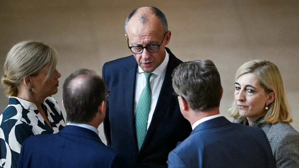 FILE PHOTO: German Chancellor Friedrich Merz speaks to Interior Minister Alexander Dobrindt, Minister for Special Tasks and Head of the Federal Chancellery Nina Warken, Health Minister Carsten Linnemann and German Parliament President Julia Kloeckner, during a plenary session of the lower house of parliament, the Bundestag, in Berlin, Germany September 25, 2026. REUTERS/Annegret Hilse/File Photo