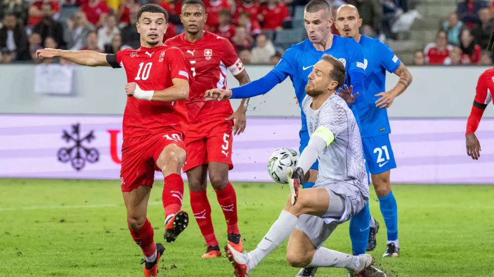 Zeki Amdouni, left, from Switzerland plays against Jan Oblak, right, from Slovenia during the UEFA Nations League soccer match between Switzerland and Slovenia in Lucerne, Switzerland, Saturday, Oct. 3, 2026. (Urs Flueeler/Keystone via AP)