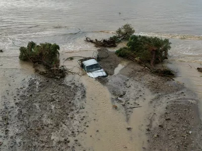 A drone view of a car and trees washed into the sea, after heavy rain continues to affect parts of Crete, prompting authorities to maintain severe weather warnings, in Therma near Ierapetra, Crete island, Greece, October 3, 2026. REUTERS/Stefanos Rapanis   TPX IMAGES OF THE DAY