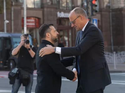 In this photo provided by the Press Service of The President of Ukraine, Ukraine's President Volodymyr Zelenskyy, left, shakes hand with German Chancellor Friedrich Merz at the Independence square in Kyiv, Ukraine, Sunday, Oct. 4, 2026. (Press Service of The President of Ukraine via AP)