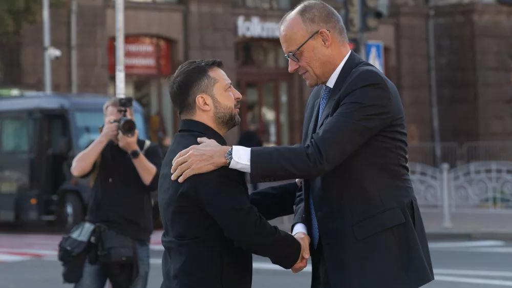 In this photo provided by the Press Service of The President of Ukraine, Ukraine's President Volodymyr Zelenskyy, left, shakes hand with German Chancellor Friedrich Merz at the Independence square in Kyiv, Ukraine, Sunday, Oct. 4, 2026. (Press Service of The President of Ukraine via AP)