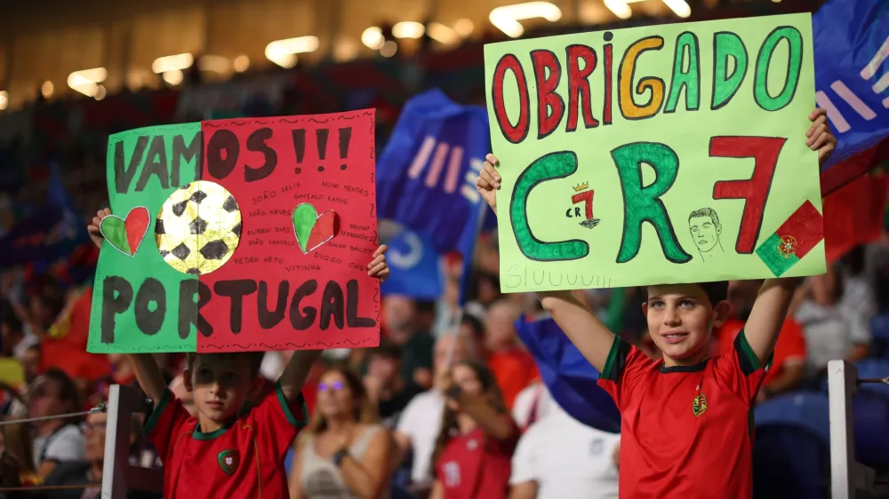 Portugal young fans hold up posters on the stands before the Nations League soccer match between Portugal and Norway in Porto, Portugal, Sunday, Oct. 4, 2026. (AP Photo/Luis Vieira)