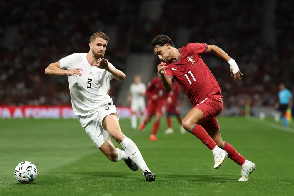 Portugal's Joao Felix drives the ball past Norway's Kristoffer Ajer, left, during the Nations League soccer match between Portugal and Norway in Porto, Portugal, Sunday, Oct. 4, 2026. (AP Photo/Luis Vieira)
