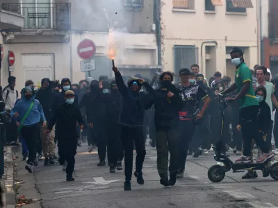 French masked high school students react in a street amid clashes near the Lycee Deodat-de-Severac high school as part of nationwide protests by high school students to demand the hiring of substitute teachers, increased resources and better learning conditions, in Toulouse as more than 400 schools remain closed following days of student protests that have escalated into violence in some places, France, October 2, 2026. REUTERS/Nacho Doce   TPX IMAGES OF THE DAY