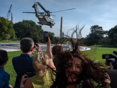 Members of the press watch as Marine One with President Donald Trump aboard lifts off from the South Lawn of the White House, Friday, Oct. 2, 2026, in Washington. (AP Photo/Mark Schiefelbein)