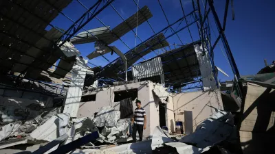A Palestinian young man stands amid the debris of Al-Hassayna family's company warehouse, damaged during the war, in Gaza City, September 28, 2026. REUTERS/Dawoud Abu Alkas